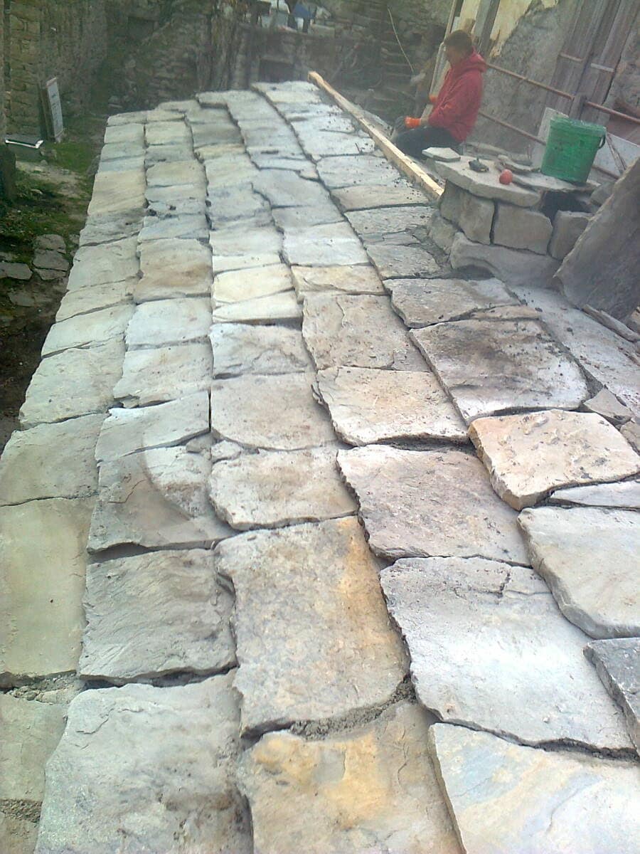 Stone paving being laid, joints still open.