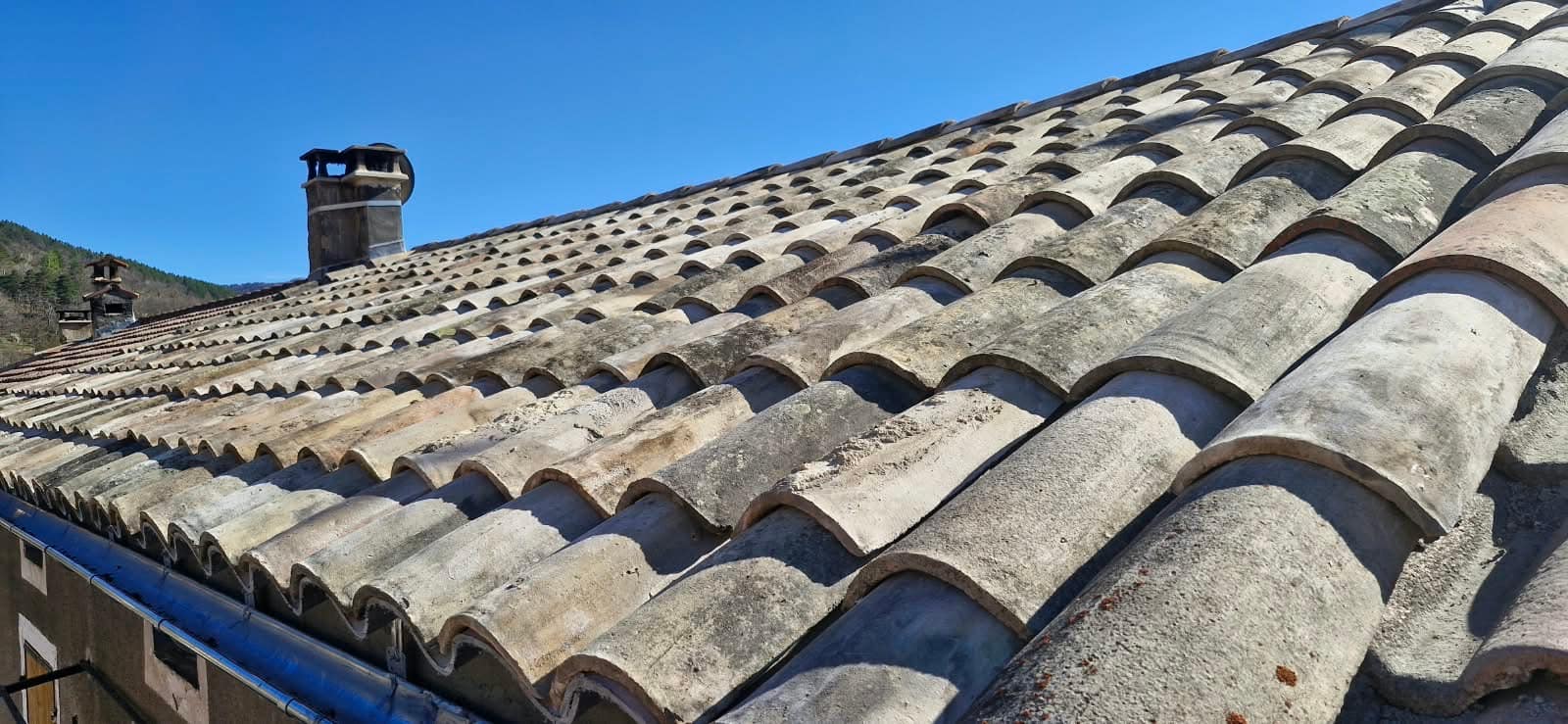 Canal tile roof and its chimney stacks, facing the mountains.